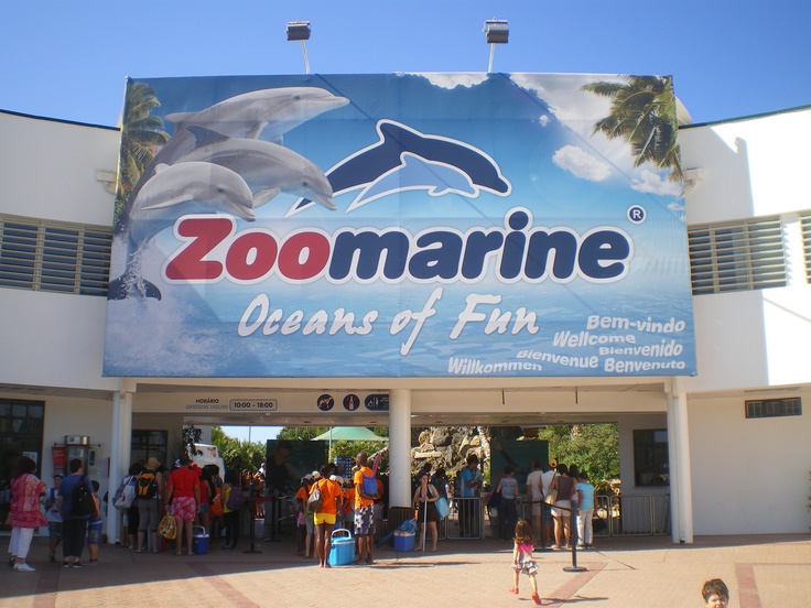 Zoomarine entrance with a dolphin sign and visitors